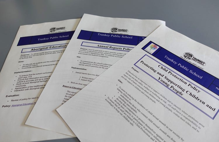 3 Trunkey Public School policies sitting on a blue table