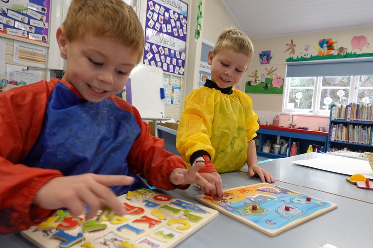 Two children attending Trunkey Public School playgroup completing puzzles.