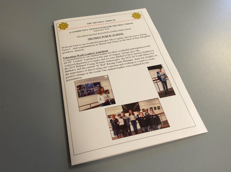 Copy of the Trunkey Tribune laying on a blue table.