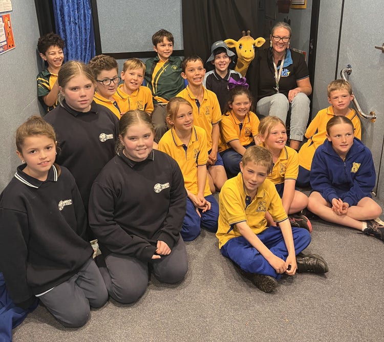 Stage 2 students from the Heritage Country Small Schools inside the Life Education Van with educator Maree and Healthy Harold.