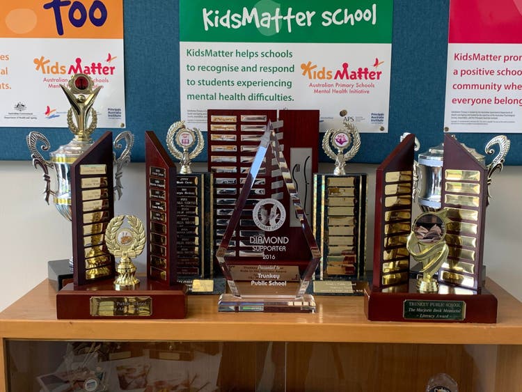 Multiple Trunkey Public School trophies displayed on a shelf
